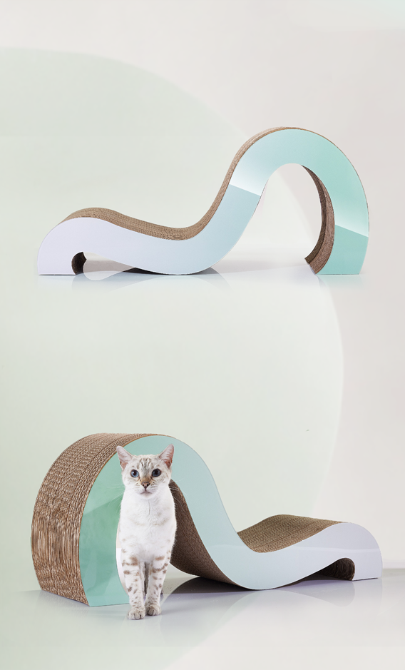 A cat standing in front of a contemporary, wave-shaped scratching post and lounge with a white, brown, and teal design.