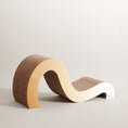 Load image into Gallery viewer, A chic, S-shaped piece of furniture with sleek, curved surfaces and a premium cardboard textured component on one side, the Mint Mint - Modern Cat Scratcher & Stretching Board by Mint Mint is showcased against a neutral background.
