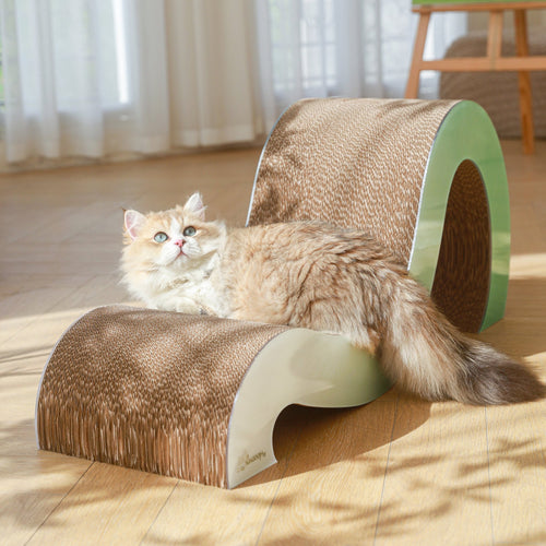 A fluffy cat with light brown fur lounges on the Mint Mint - Modern Cat Scratcher & Stretching Board in a sunlit room with wooden floors and sheer curtains, keeping its claws healthy.