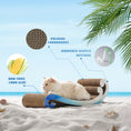 Load image into Gallery viewer, A white cat sits on the Nelo Nelo - Surf Wave Cat Furniture & Cardboard Scratcher, which is made of premium recycled cardboard, mirrored acrylic material, and non-toxic corn glue, placed on a sandy beach with palm leaves and a clear sky in the background.
