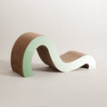 Load image into Gallery viewer, Introducing the Mint Mint - Modern Cat Scratcher & Stretching Board by Mint Mint, featuring a wavy design crafted from brown and light green materials. This minimalist piece stands out against a neutral background with its pet-visible colors for added vibrancy.
