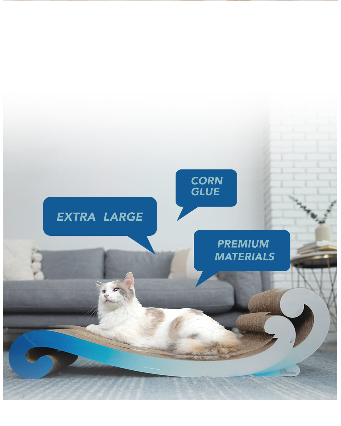 A white and grey cat lounges on a blue, wave-shaped scratching board with labels highlighting its features: "Extra Large," "Corn Glue," and "Premium Materials.